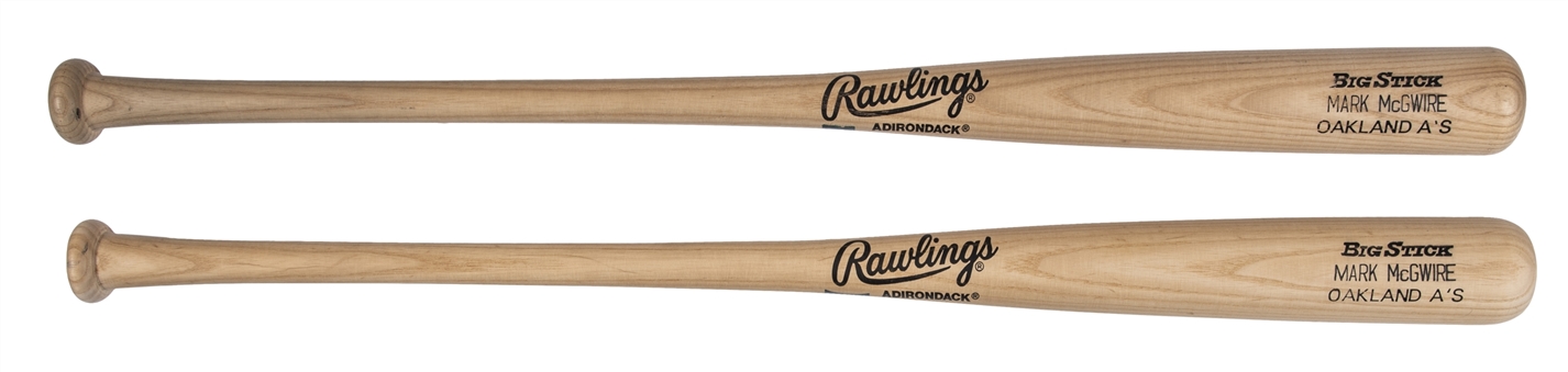 Lot of (2) 1990 & 1992 Mark McGwire Game Issued Oakland As Rawlings 256B Model Bats (PSA/DNA)